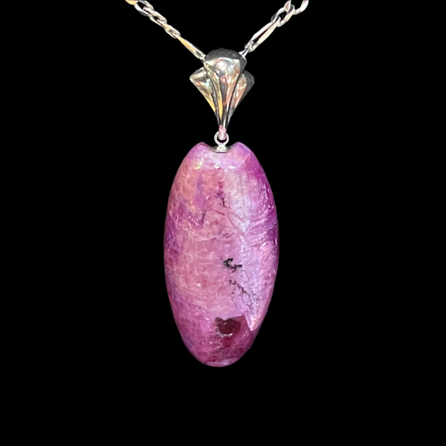 Ruby pendant with a cat's eye finish on sterling silver necklace. Made in Alaska by a member of a recognized indigenous tribe.