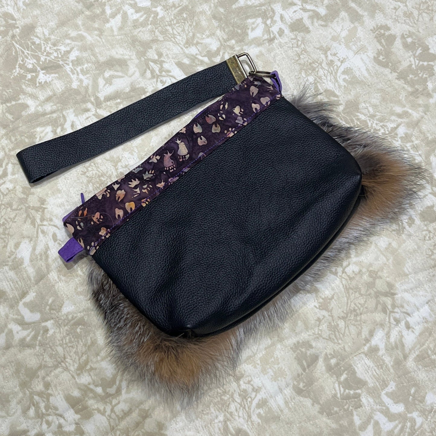 Cross Fox fur clutch purse with strap. Made from leather and cross fox fur with purple animal tracks trim