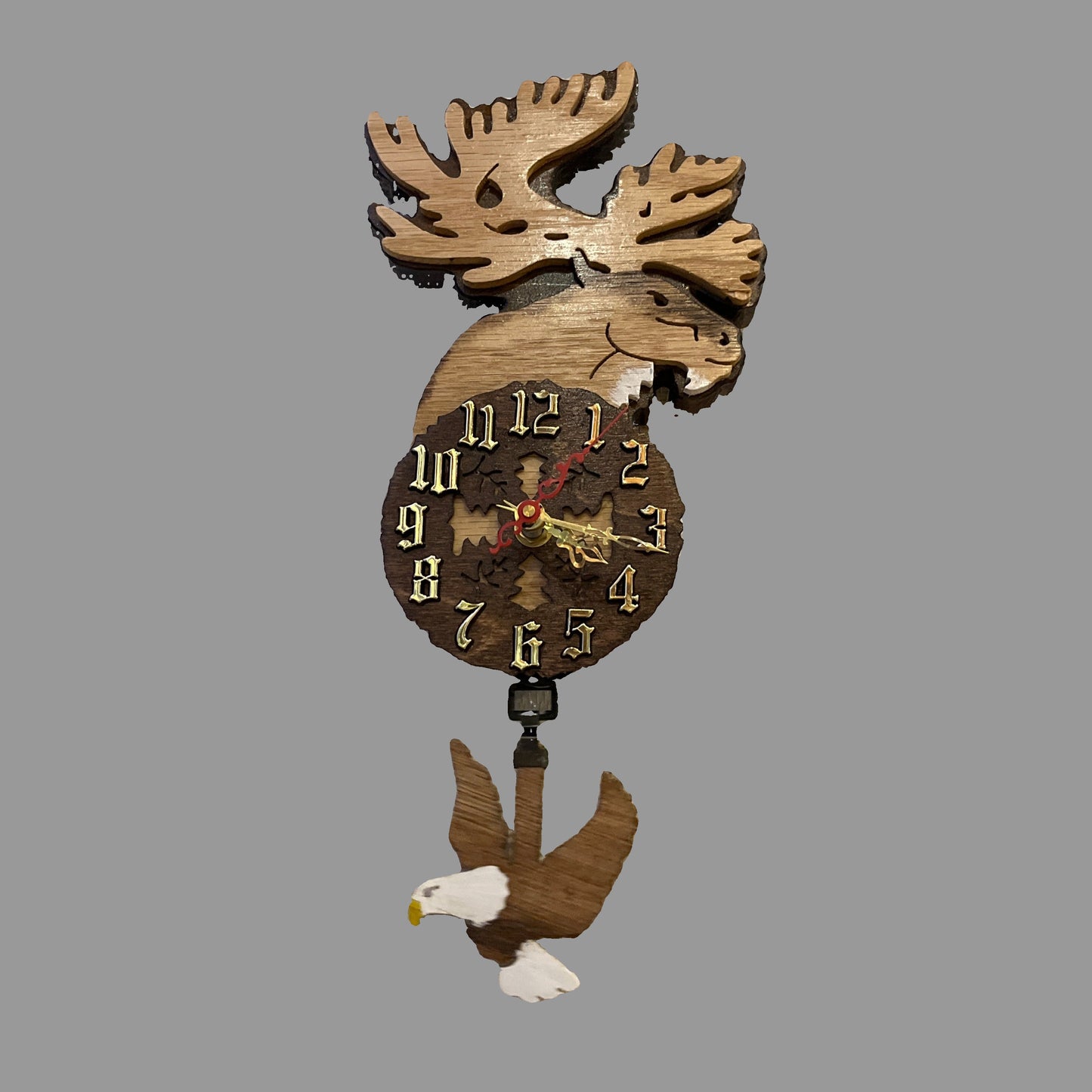 Wooden caribou pendulum clock, hand scroll sawed, with high quality quartz movements, designed for years of service. One AA battery included.