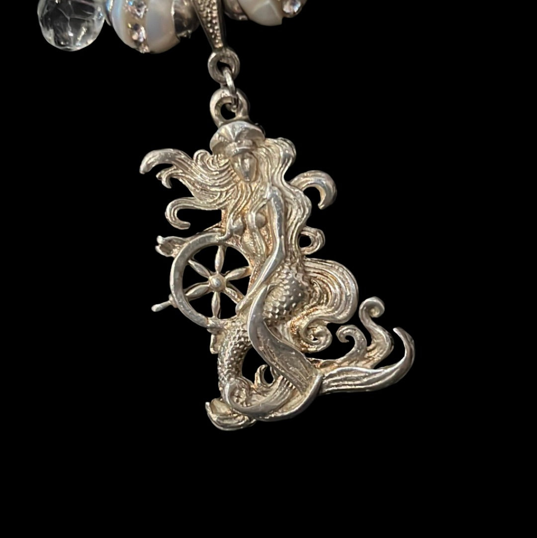 Captain of her own ship, this exquisite silver mermaid is a Buzzwinkle's exclusive on a peridot, topaz, pearl, and aquamarine double chain.