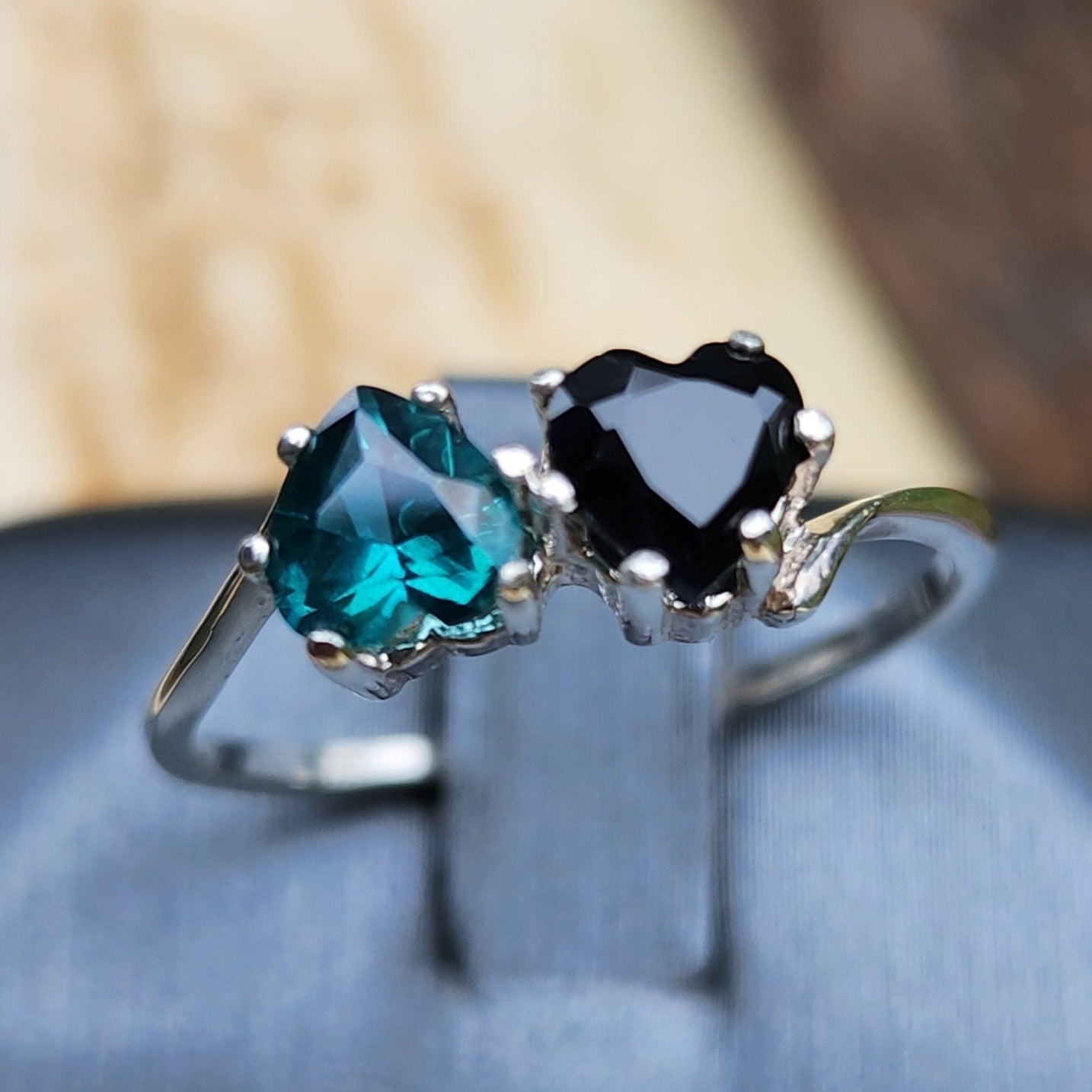 Black Sapphire and teal Topaz hearts size 7.5 in silver.