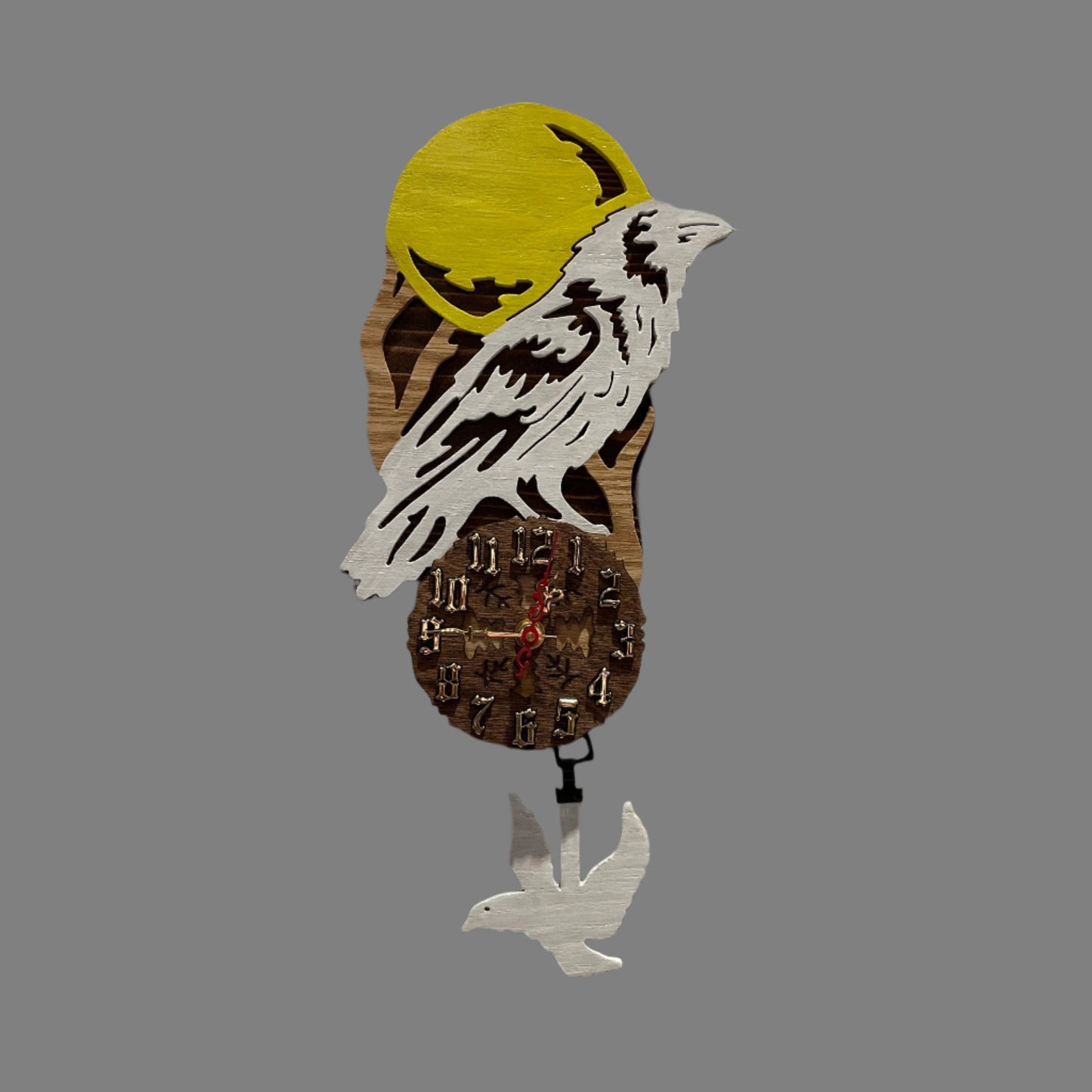 White raven pendulum clock, hand scroll sawed, with high quality quartz movements, designed for years of service. One AA battery included. Certified Made in Alaska.