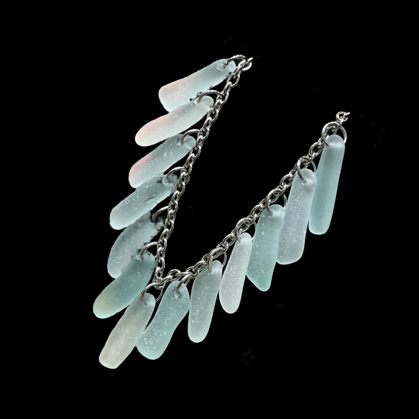 7-inch lobster claw chain bracelet with 13 pieces of long pale colored sea glass from Seldovia.
