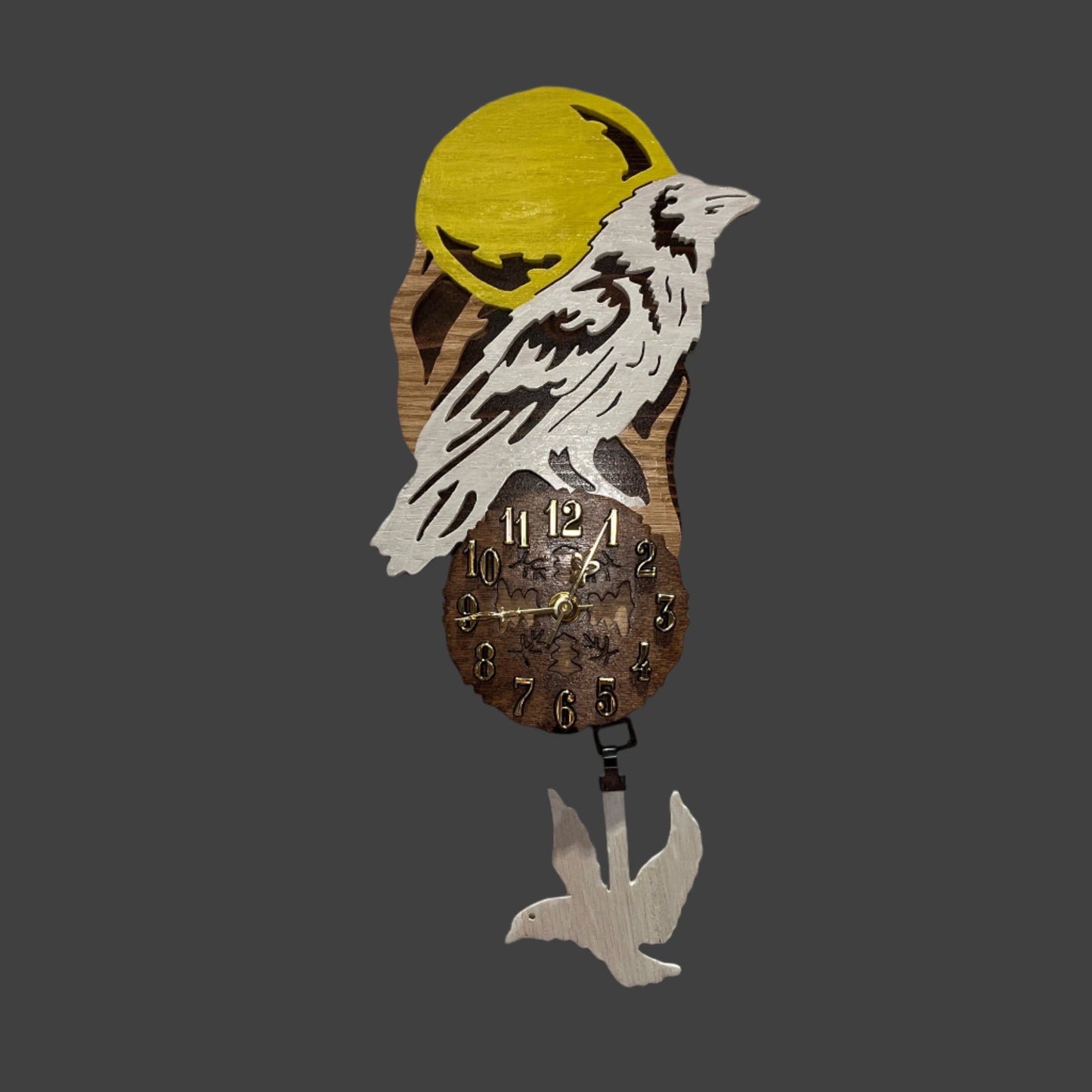 White raven pendulum clock, hand scroll sawed, with high quality quartz movements, designed for years of service. One AA battery included. Certified Made in Alaska.