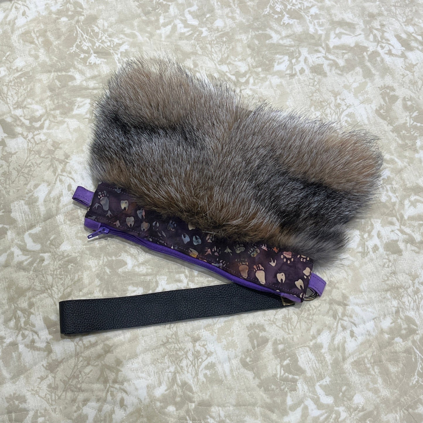 Cross Fox fur clutch purse with strap. Made from leather and cross fox fur with purple animal tracks trim