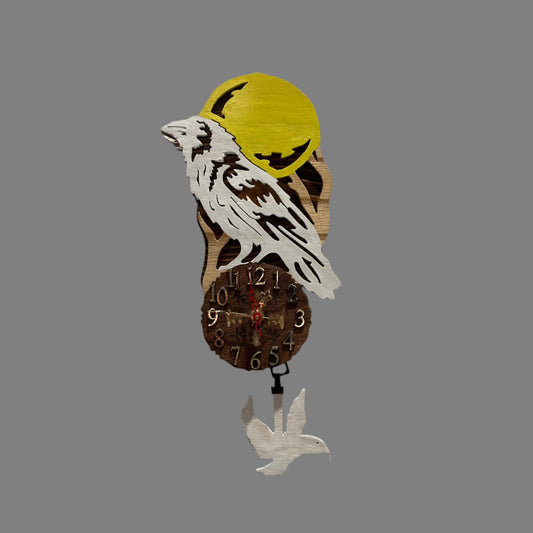 White raven pendulum clock, hand scroll sawed, with high quality quartz movements, designed for years of service. One AA battery included. Certified Made in Alaska.