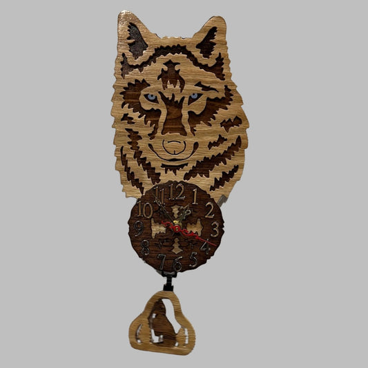 Wood wolf clock with howling wolf pendulum, hand scroll sawn, with high quality quartz movements, designed for years of service. One AA battery included. Certified Made in Alaska.