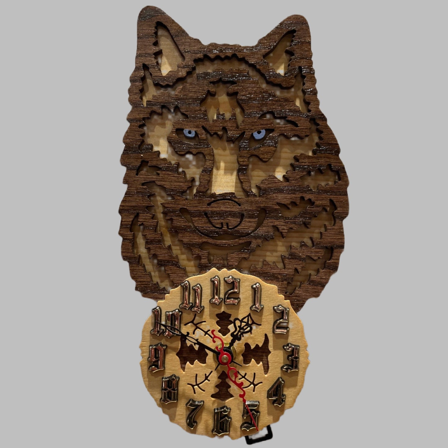 Wood wolf clock with howling wolf pendulum, hand scroll sawn, with high quality quartz movements, designed for years of service. One AA battery included. Certified Made in Alaska.