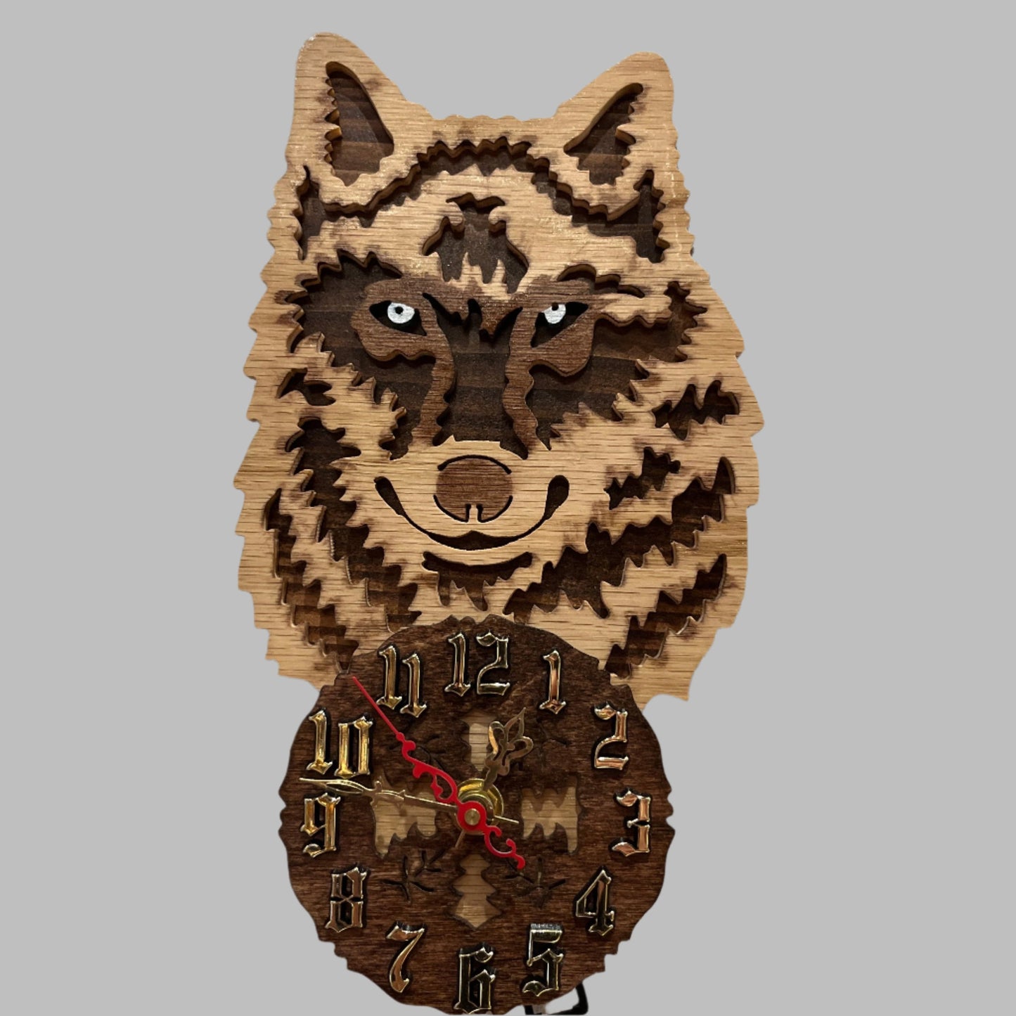 Wood wolf clock with howling wolf pendulum, hand scroll sawn, with high quality quartz movements, designed for years of service. One AA battery included. Certified Made in Alaska.