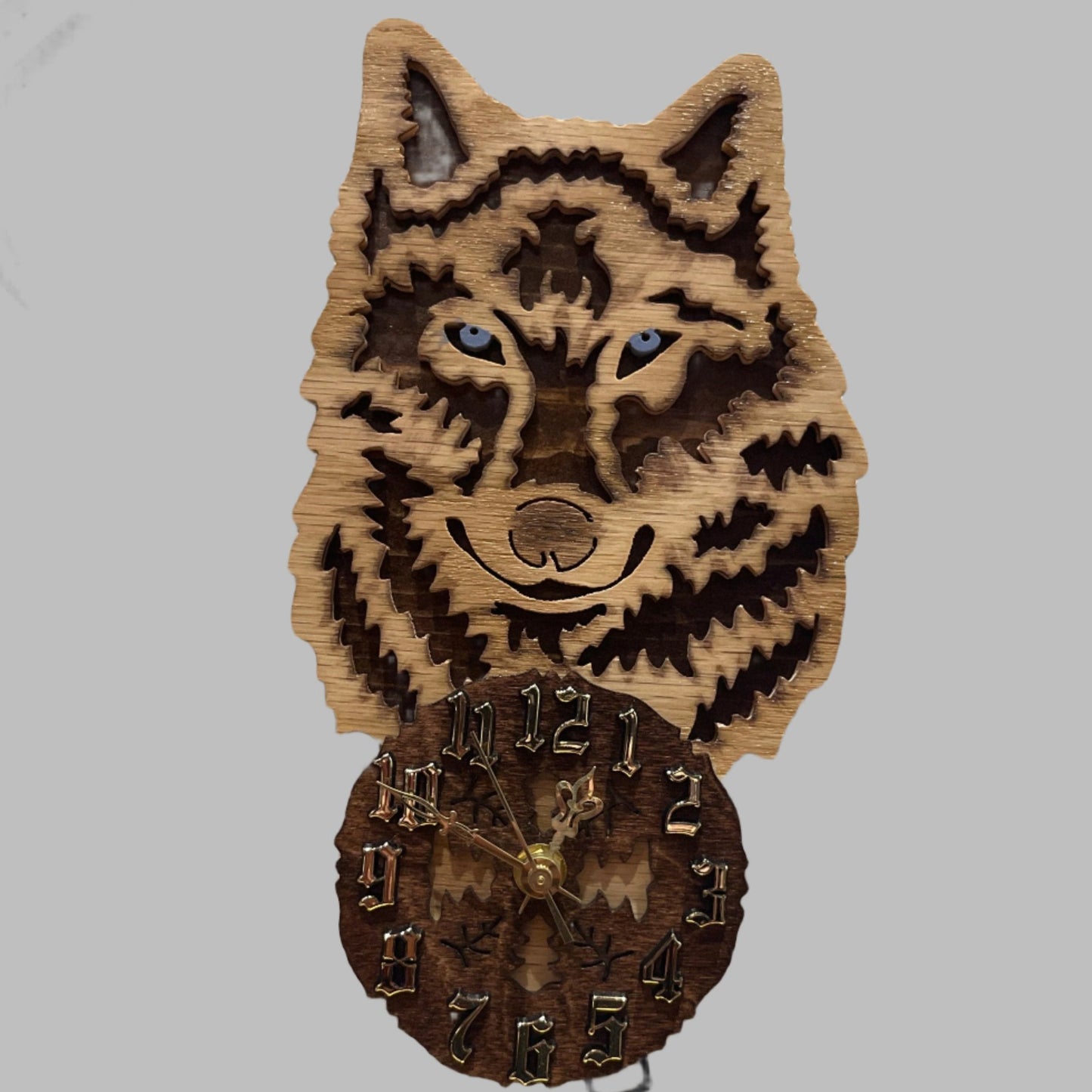 Wood wolf clock with howling wolf pendulum, hand scroll sawn, with high quality quartz movements, designed for years of service. One AA battery included. Certified Made in Alaska.