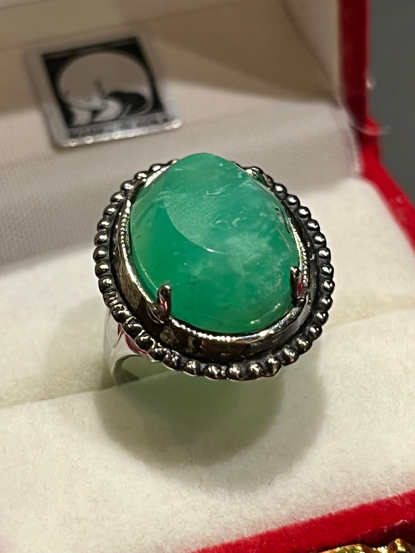 Bright green Chrysoprase set in an antique silver ring setting. This unique piece of jewelry is authentic Alaska Native art created by an enrolled member of an Alaska Native tribe. Certified Silver Hand and Made in Alaska jewelry.