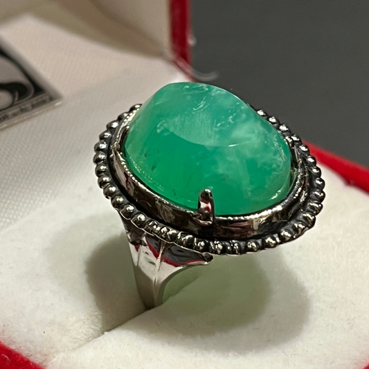 Bright green Chrysoprase set in an antique silver ring setting. This unique piece of jewelry is authentic Alaska Native art created by an enrolled member of an Alaska Native tribe. Certified Silver Hand and Made in Alaska jewelry.