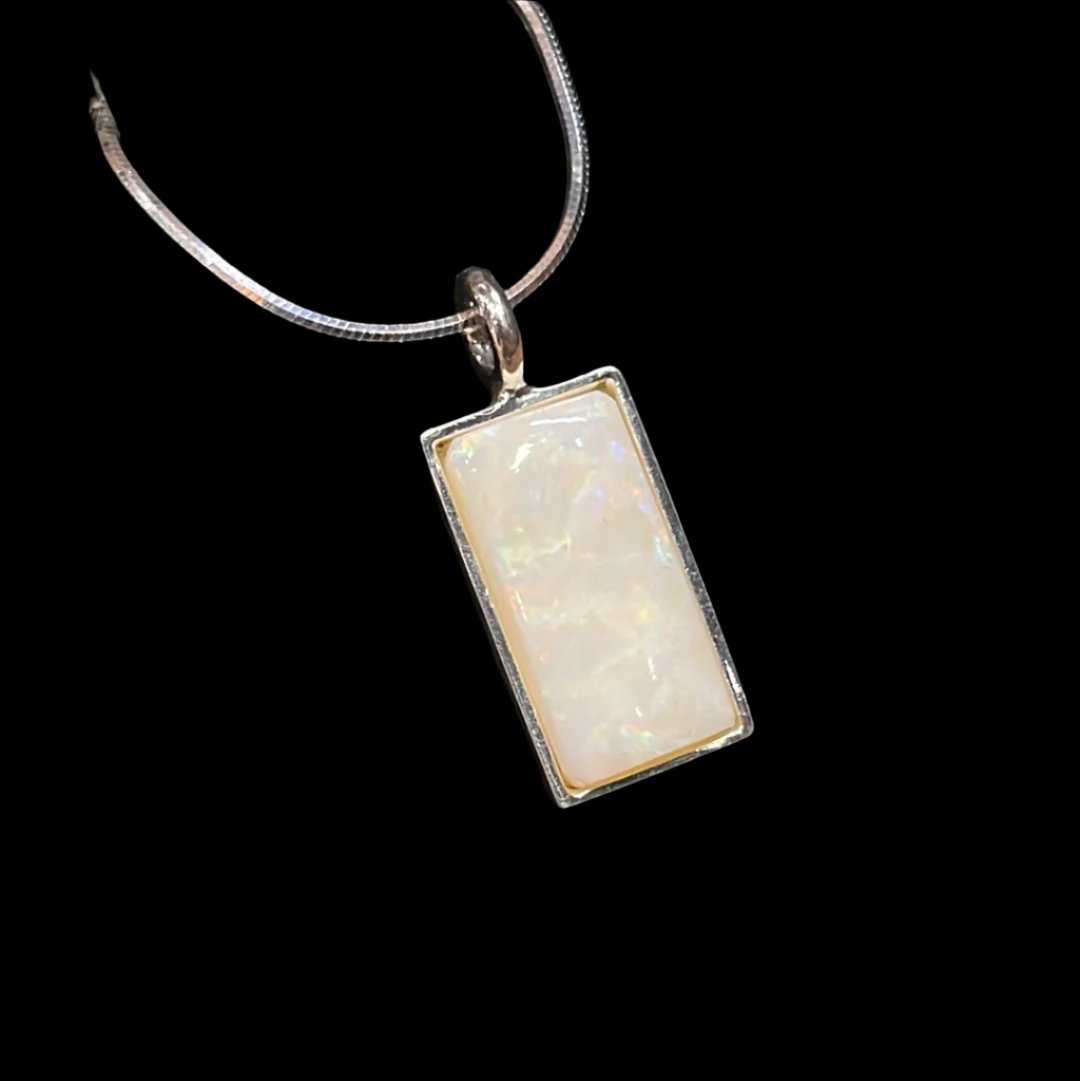 Rectangular 8.79 carat White Opal pendant in sterling on snake chain. This unique piece of jewelry is authentic Alaska Native art created by an enrolled member of an Alaska Native tribe.