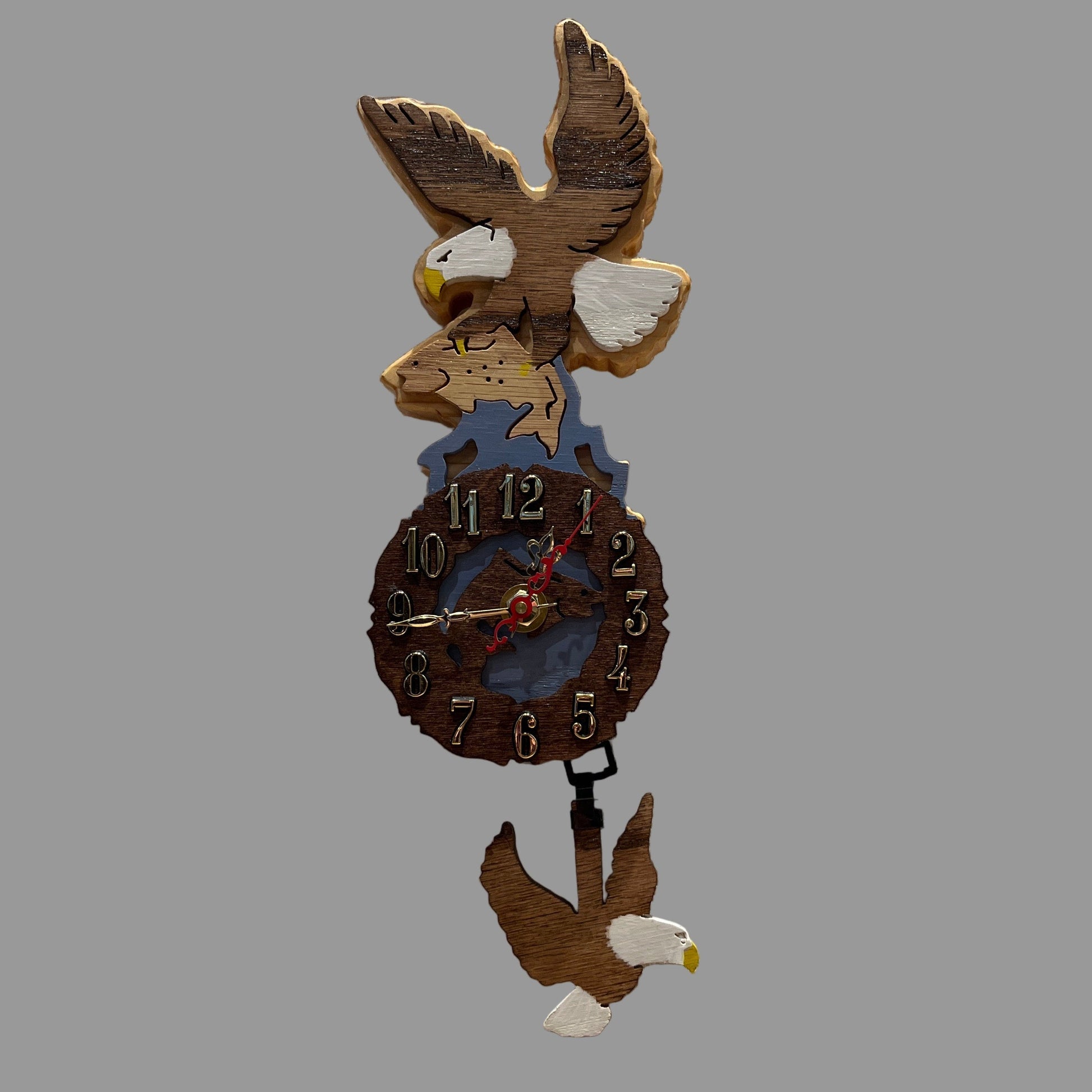 Wooden clock with eagle design, hand scroll sawn with eagle pendulum. Made in Alaska by Alaskan Cuckoo Clocks & Design