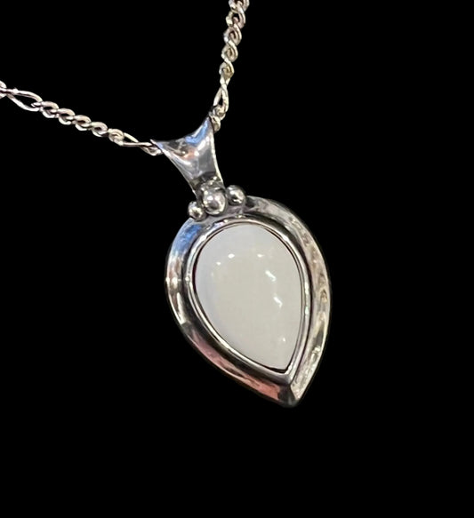 Silver pendant with a teardrop-shaped reversible white ivory and green Alaskan Kobuck Jade pendant. Made in Alaska