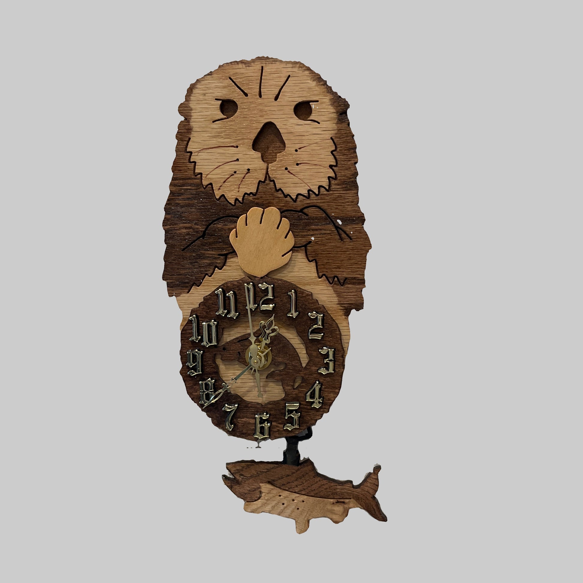 Wooden clock with otter design, hand scroll sawn with eagle pendulum. Made in Alaska by Alaskan Cuckoo Clocks & Design